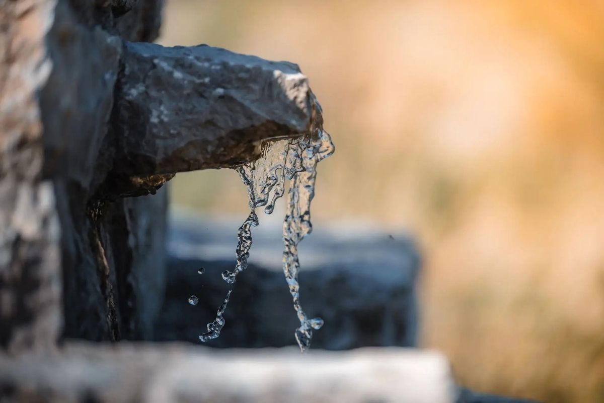 Stone fountain with flowing water at winery Barovic